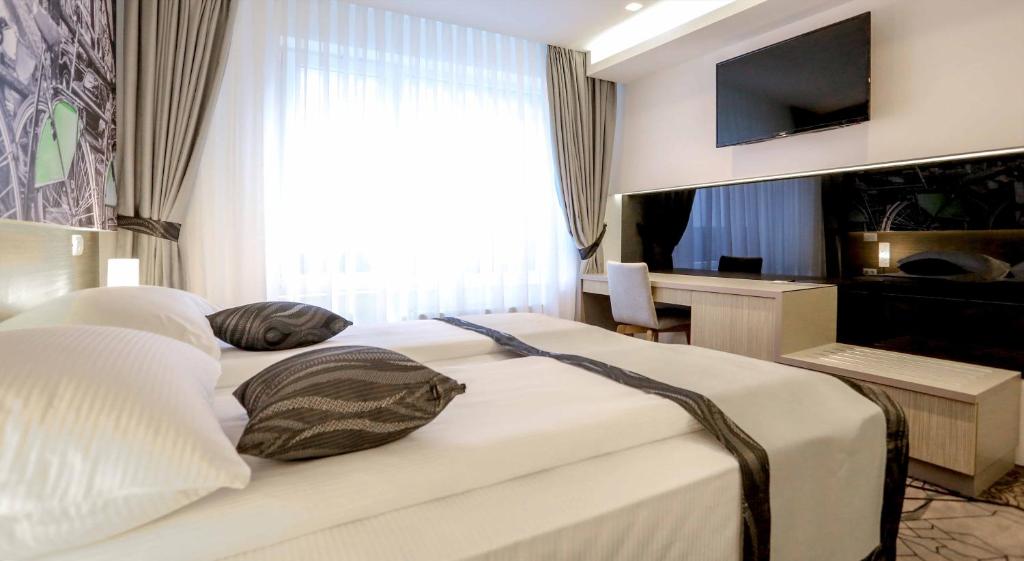 Postel nebo postele na pokoji v ubytování Hotel Grad