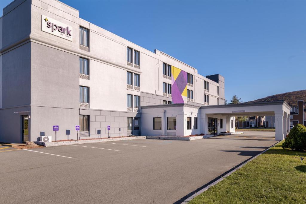 a rendering of the front of a hotel with a parking lot at Spark by Hilton Fishkill in Fishkill