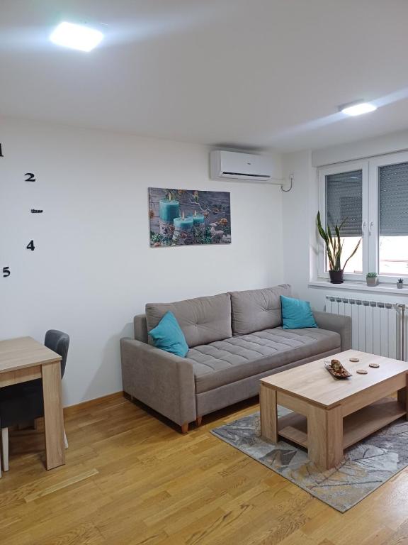 a living room with a couch and a table at Apartman MD in Lukavica