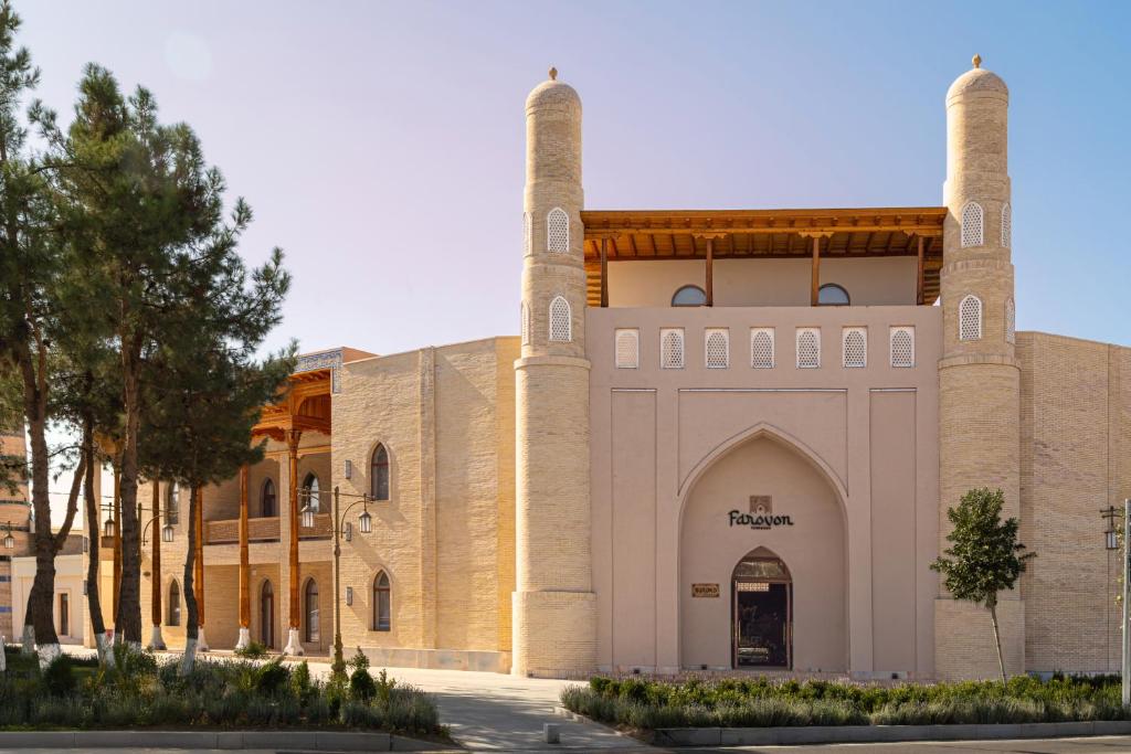 a building with two towers on top of it at Farovon Tashkent Boutique Hotel in Tashkent
