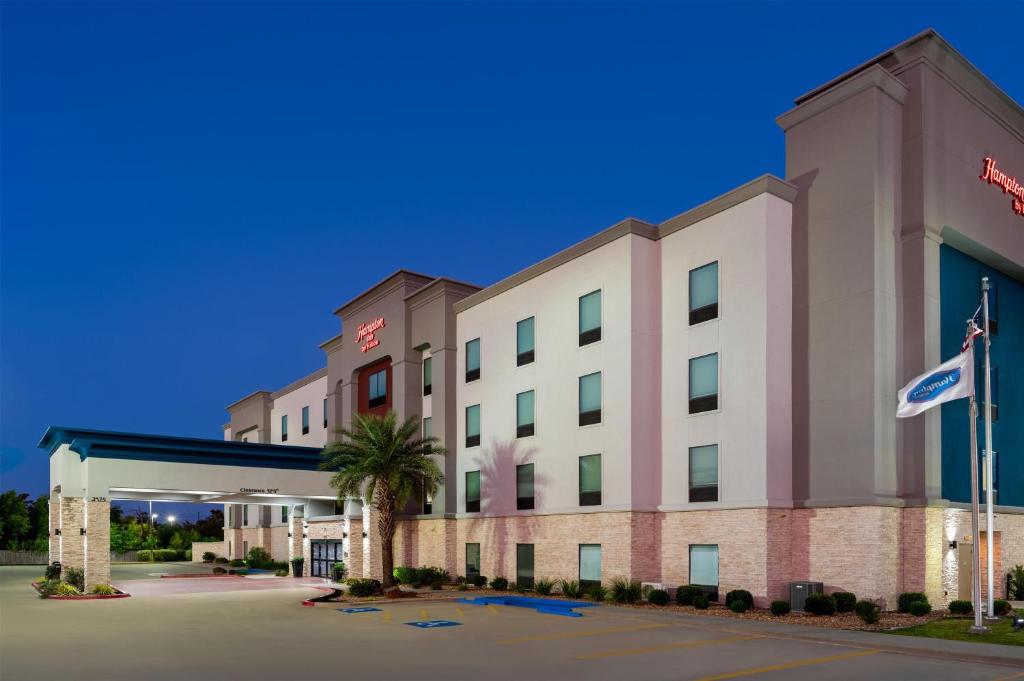 an image of a hotel with a gas station at Hampton Inn Lake Charles in Lake Charles