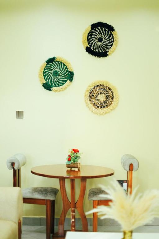 a table and some hats hanging on a wall at Eternal shine serenity in Munyonyo