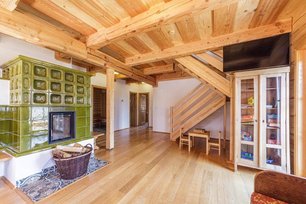a large living room with wooden ceilings and a fireplace at Roubenka Nové Hutě in Nové Hutě