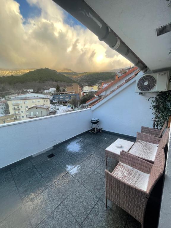 a balcony with two chairs and a view of a city at Auriga in Mijares