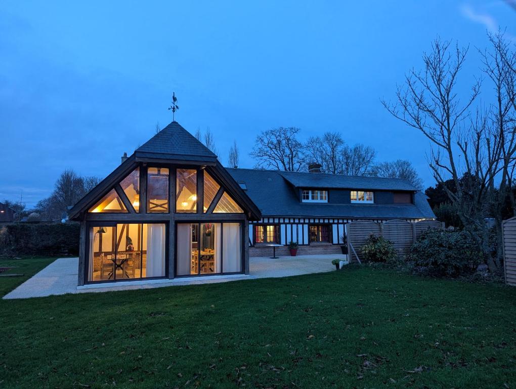 a large house with large windows on a lawn at Le Moment Normand in Émalleville
