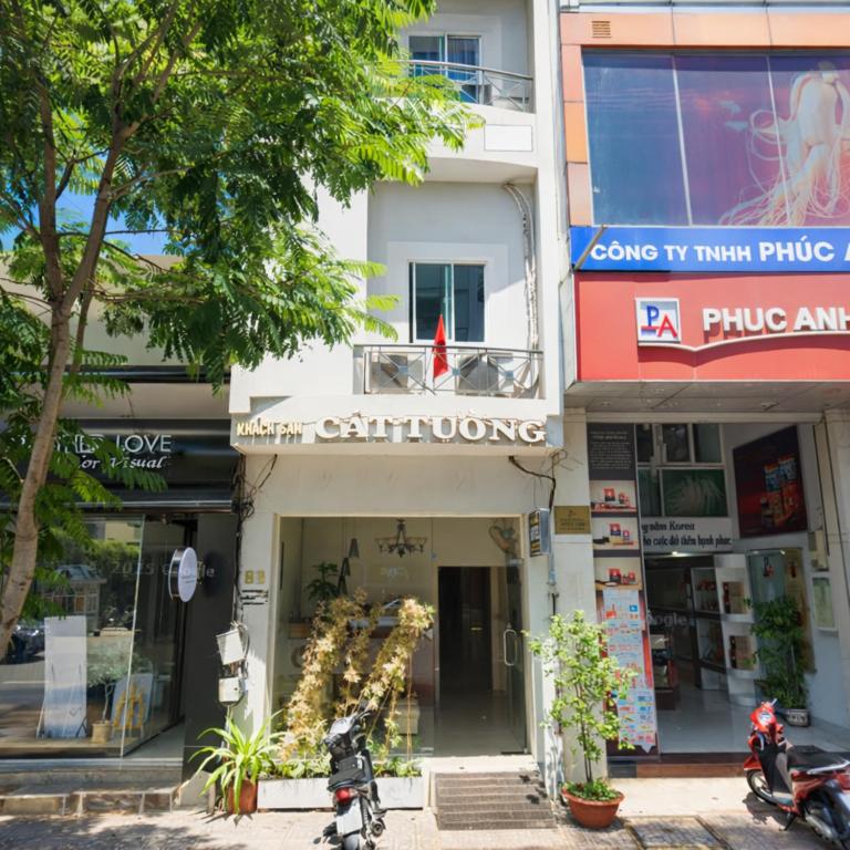 a store front of a building with motorcycles parked outside at Cát Tường Hotel in Ho Chi Minh City