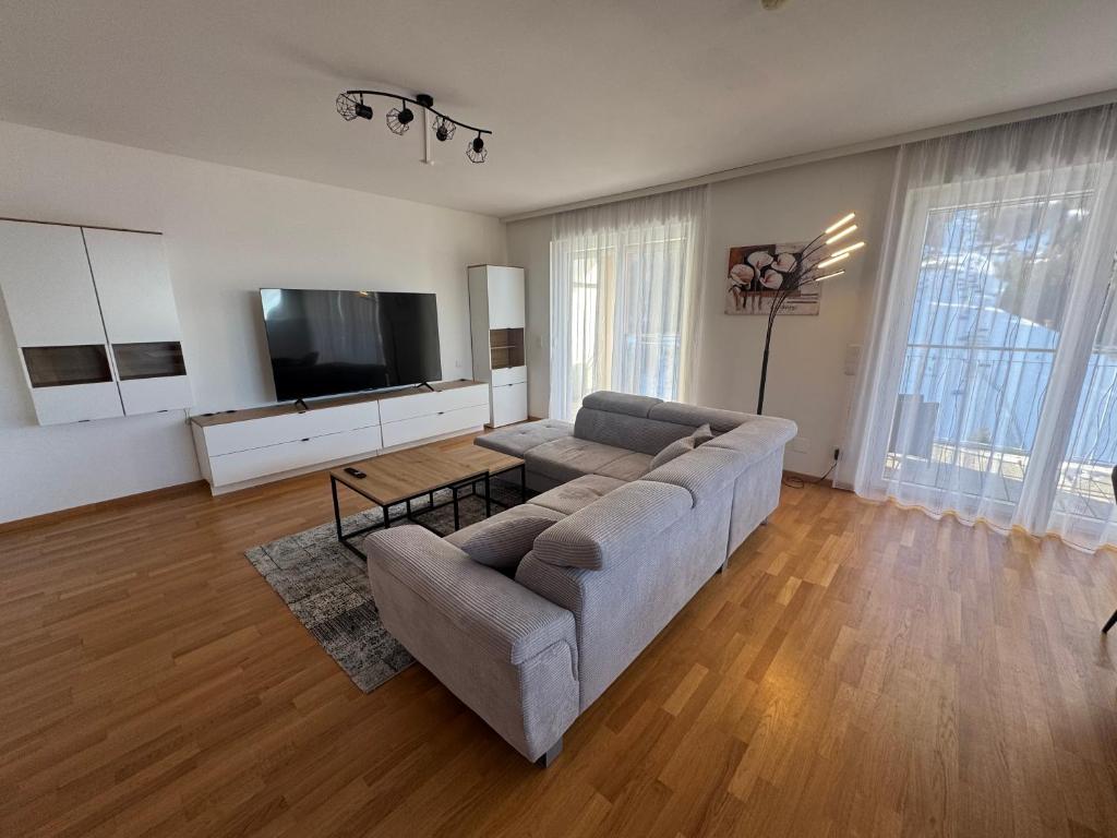 a living room with a couch and a flat screen tv at Lux 11 in Sonnenalpe Nassfeld