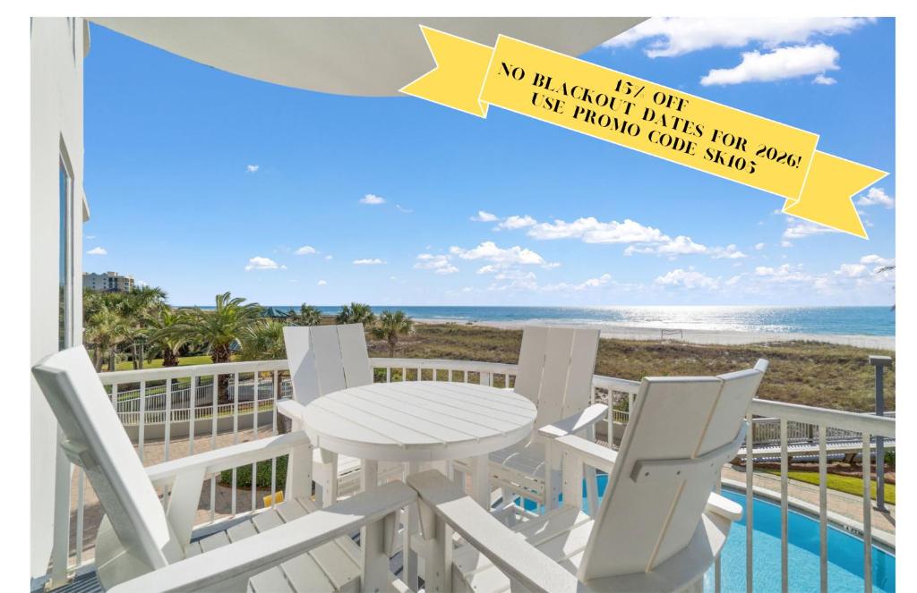 a table and chairs on a balcony with a view of the beach at Spanish Key 105 in Perdido Key