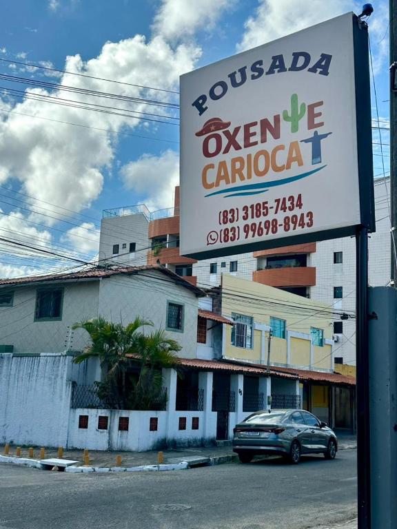 a sign for a restaurant in front of a building at Pousada Oxente Carioca in João Pessoa