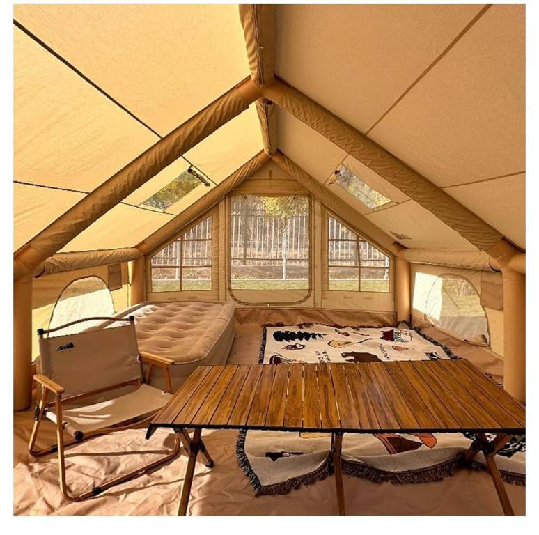 a room with a table and chairs in a tent at safari lodges in Moncarapacho
