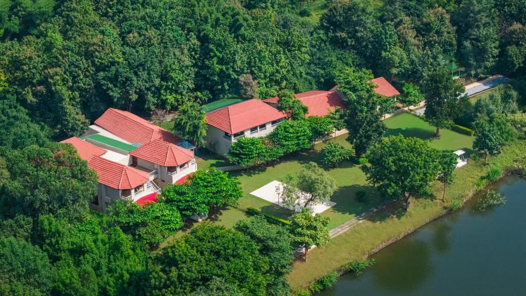 an aerial view of a house with red roofs at The Forest Chapter by Sayaji Madhai in Sohāgpur