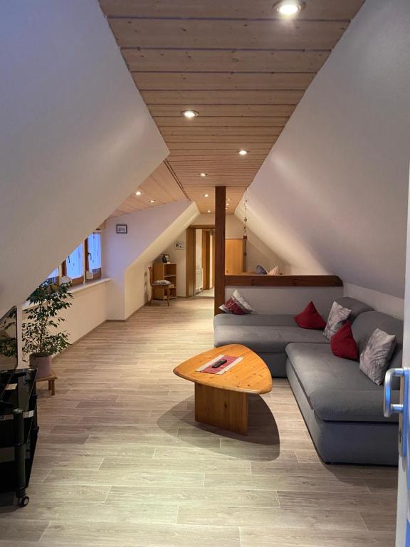 a living room with a couch and a table at Münsterblick in Wolframs-Eschenbach