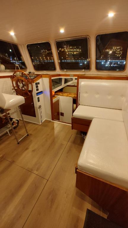 a room with a bed and a chair in a boat at Over the Sea in Barcelona