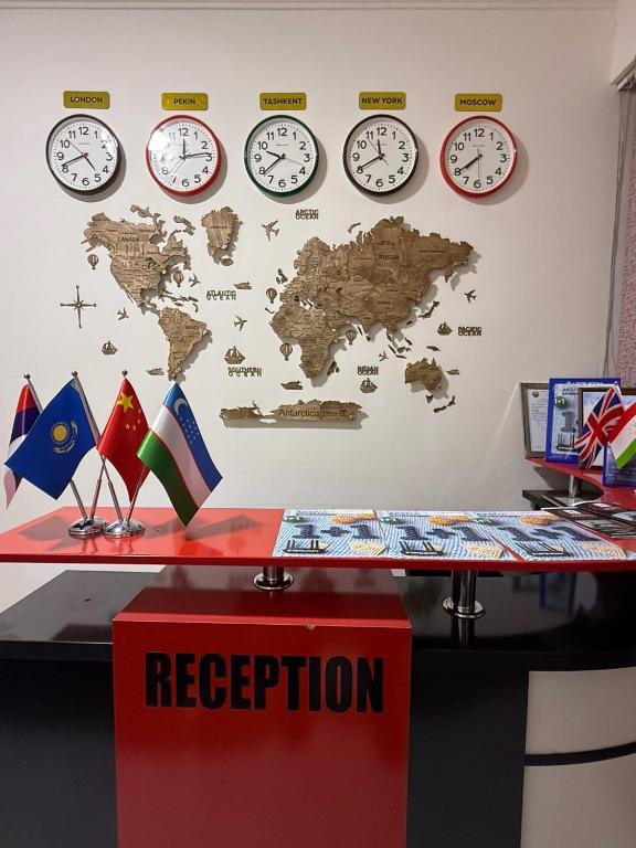 a room with clocks on a wall and a desk at Хостел Ганга in Tashkent