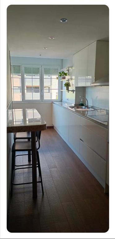 a kitchen with a table and a chair in it at Apartamento en Huesca capital in Huesca