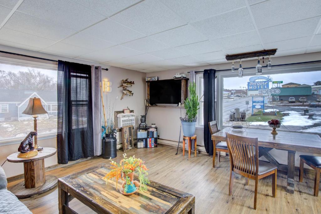 a living room with a table and a large window at Bel Aire Motel Chamberlain Near Missouri River I 90 in Chamberlain