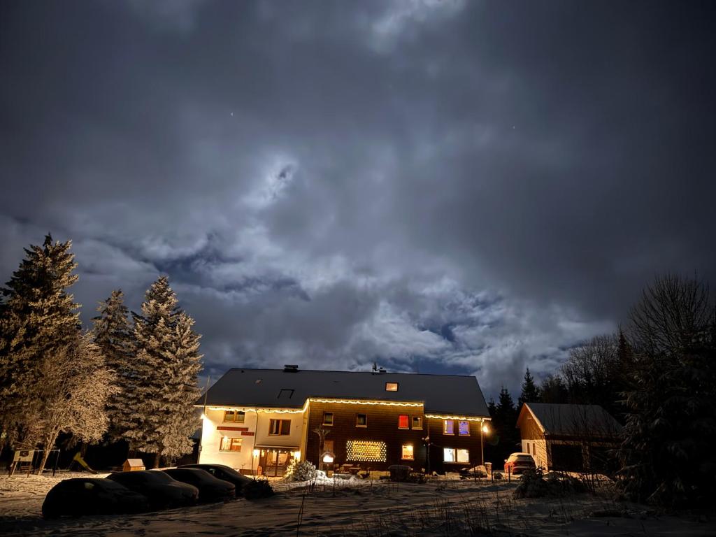 a house at night with a cloudy sky at Naturfreundehaus Brend in Neuweg