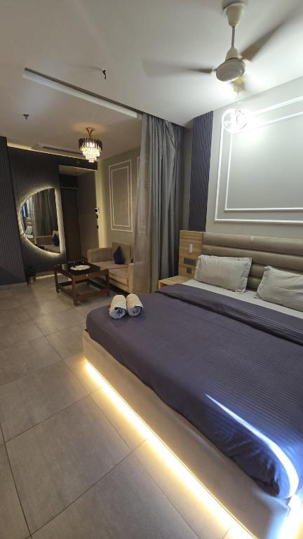 a bedroom with a large bed with lights on it at Lake Side Drift by Luxury loft 37th floor in Noida