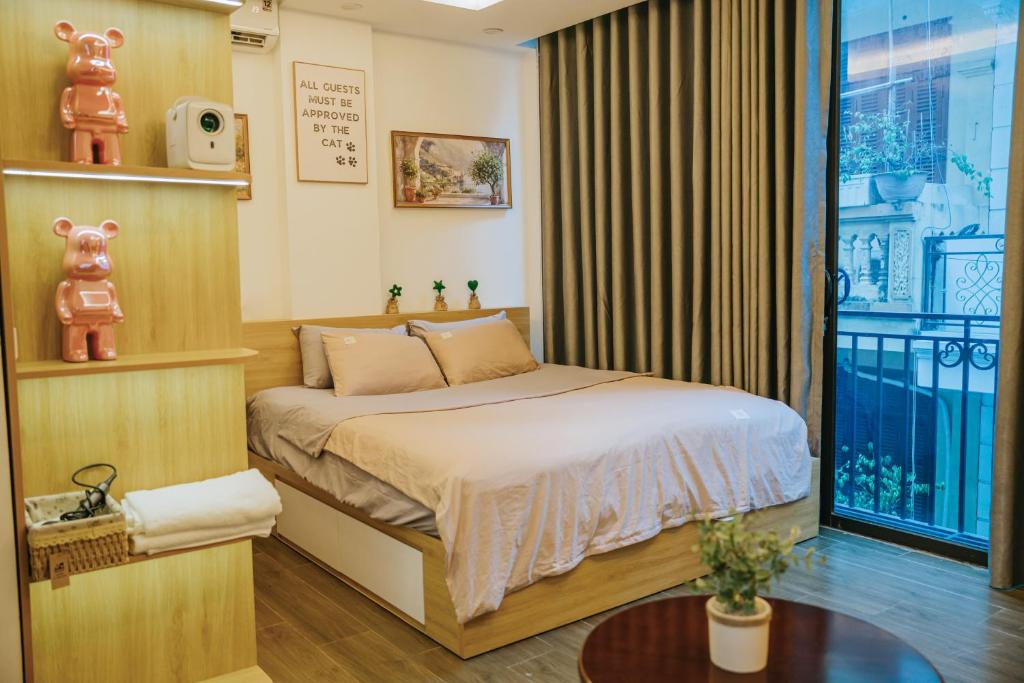 a bedroom with a bed and a large window at Dubai House in Hanoi