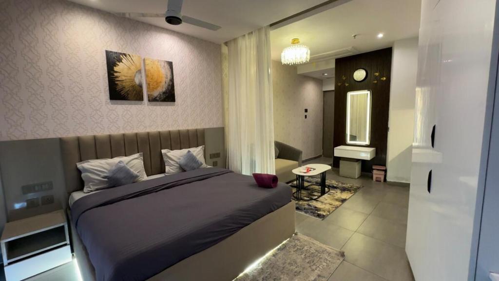 a bedroom with a large bed and a bathroom at Cozy corner by Luxury loft in Noida
