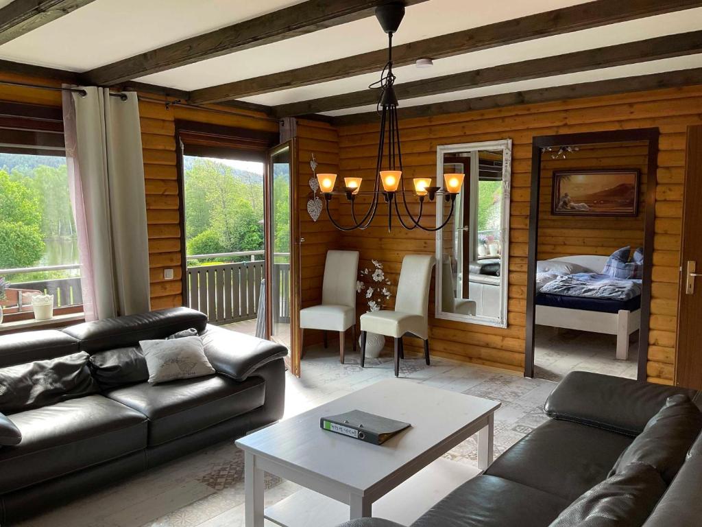 a living room with a couch and a table at Haus 12 See- und Bayerwaldblick für bis zu 10 Gäste in Arrach