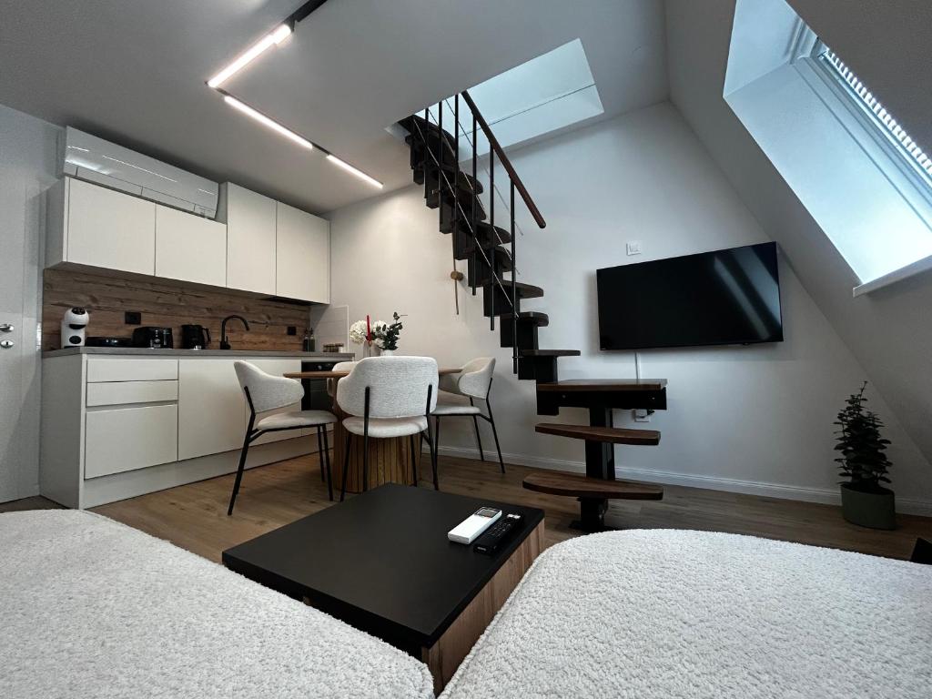 a living room with a staircase and a kitchen at Velvet Alps Bovec in Bovec
