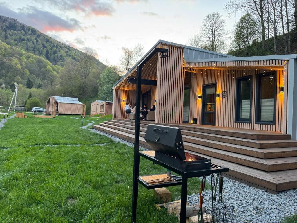 a small house with a grill in front of it at Trava Bungalow in Korostov
