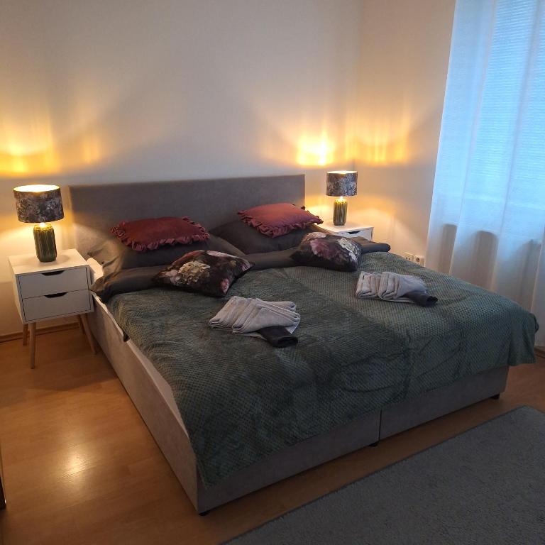a bed with two pillows on it in a bedroom at Penzión Mišell in Bardejov