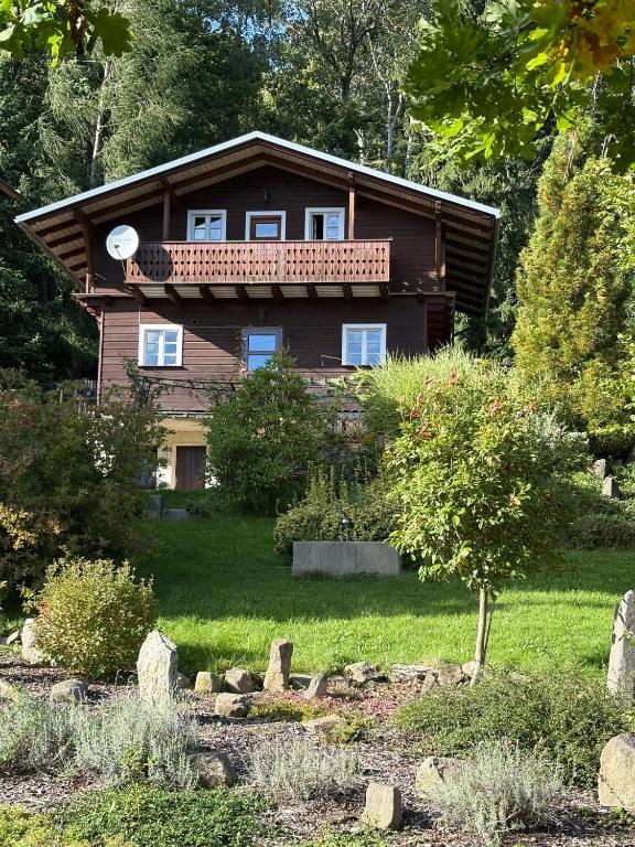 a house with a balcony on top of it at Chata Na Mechu in Dolní Podluží