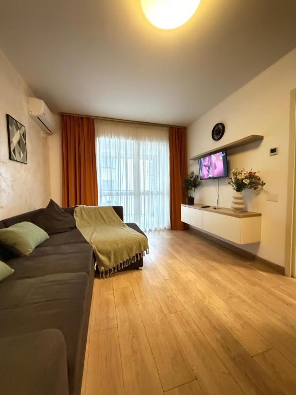 a living room with a couch and a flat screen tv at Luxury Apartments Newton by GLAM - Parking Option in Iaşi