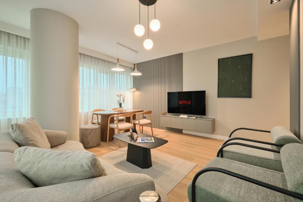 a living room with two couches and a tv at BSY Flats Well Decorated Modern Apartments With 2BR, 3BR Options in Istanbul