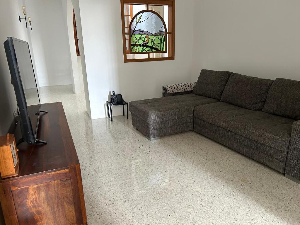 a living room with a couch and a tv at Apartment in Żebbuġ Malta in Ħal Muxi
