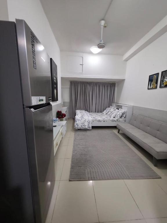 a small living room with a couch and a kitchen at Apartment in ajman in Ajman 