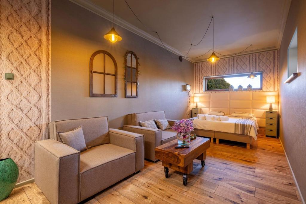 a living room with a couch and a bed and a table at Positano Apartment in Głowno