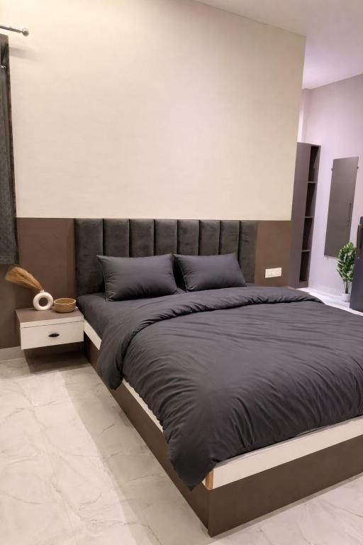 a bedroom with a large bed in a room at OddbirdStays in Indore
