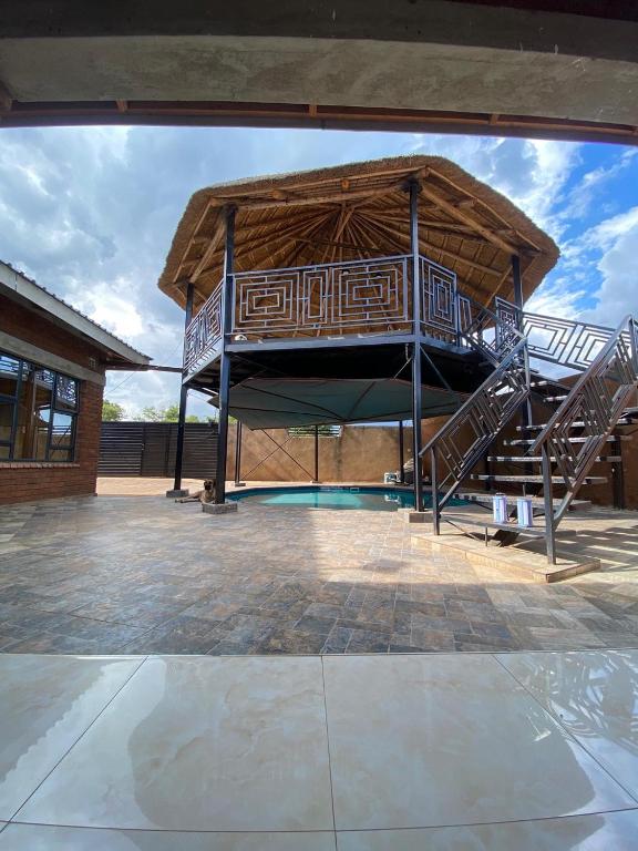 a large building with a playground with a slide at PreshyPride Guest House in Victoria Falls