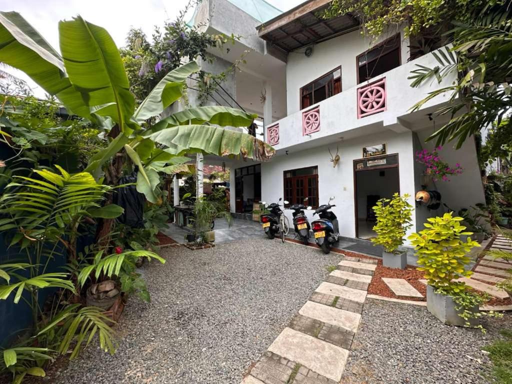a building with motorcycles parked in front of it at Bamboo Garden Inn in Goiyapana