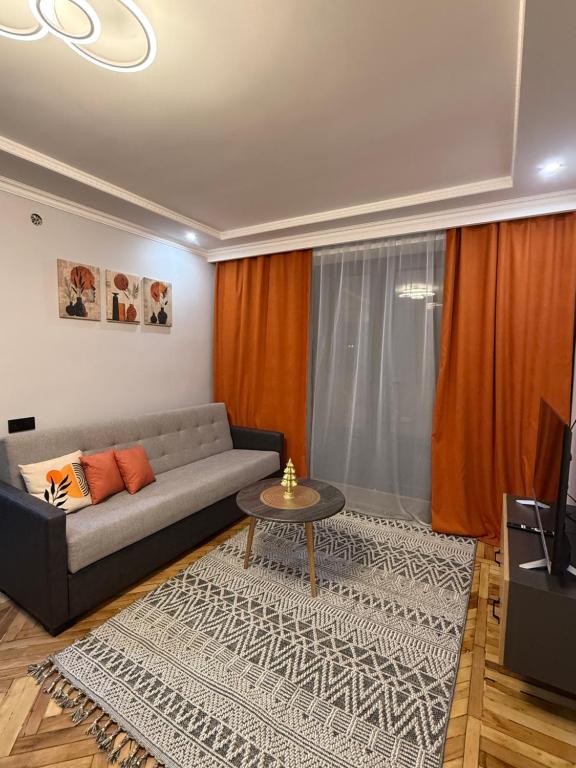 a living room with a couch and a table at Terrace house Jermuk in Jermuk