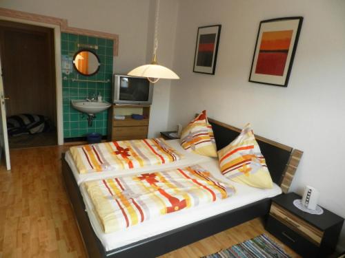 a bed with colorful pillows in a room at Hotel In der Meile in Dortmund