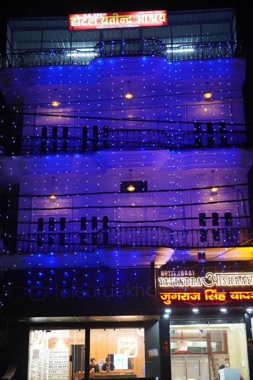a building with blue lights on the side of it at Yatindra Ashraya in Etāwah