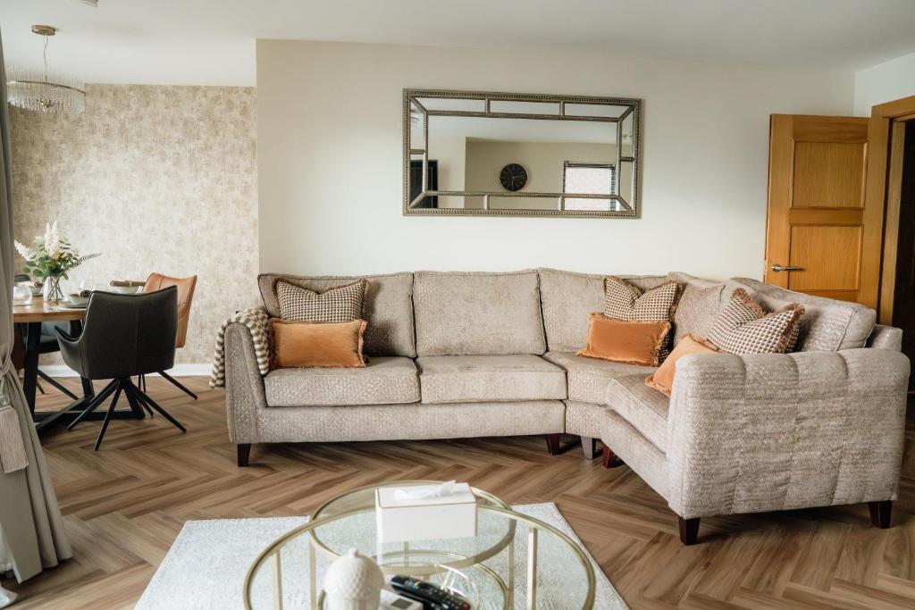 a living room with a couch and a mirror at MD Stays in Portstewart