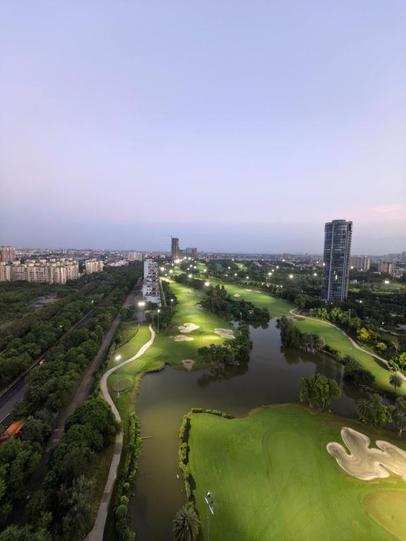 an aerial view of a golf course and a river at The Mayfair Suites by AURACHE in Greater Noida