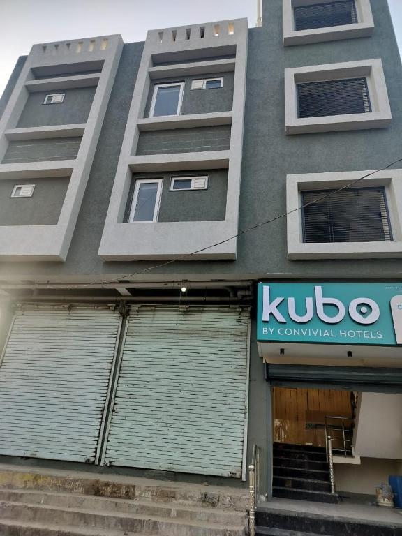 a building with a kudo sign on the side of it at Kubo by Convivial Hotels in Raipur