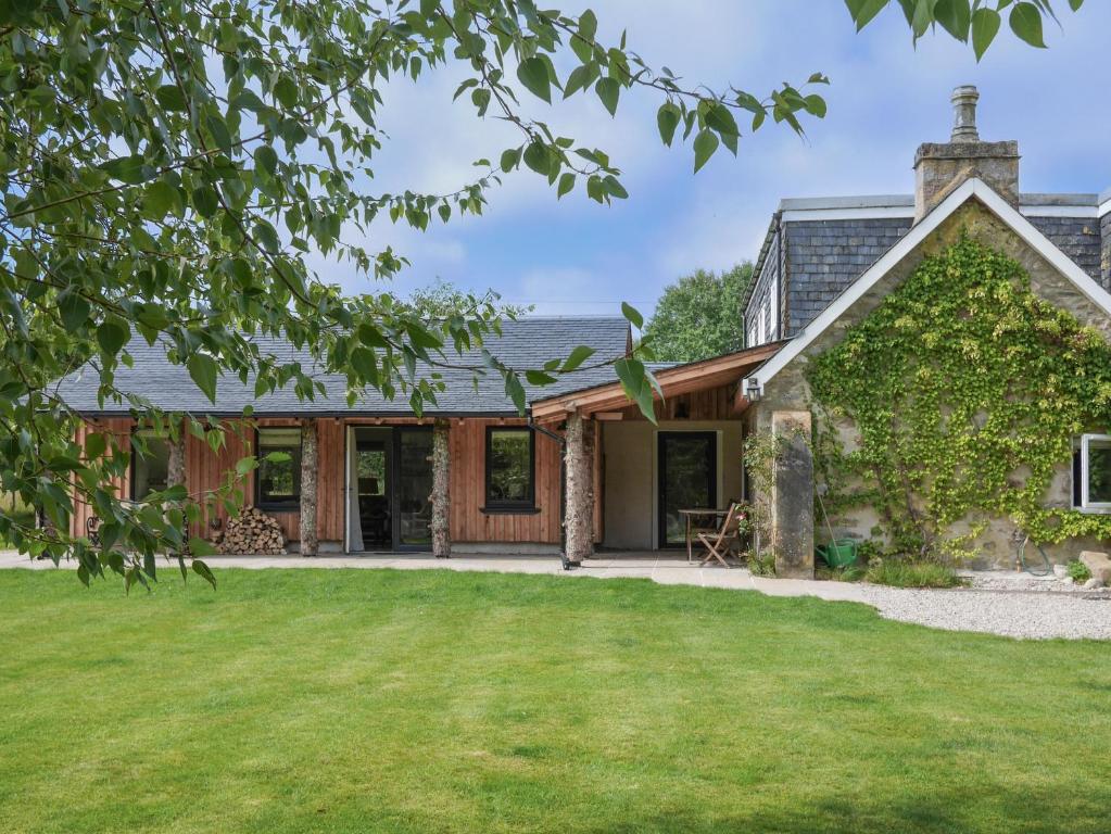 an exterior view of a house with a yard at Relugas Mill in Forres