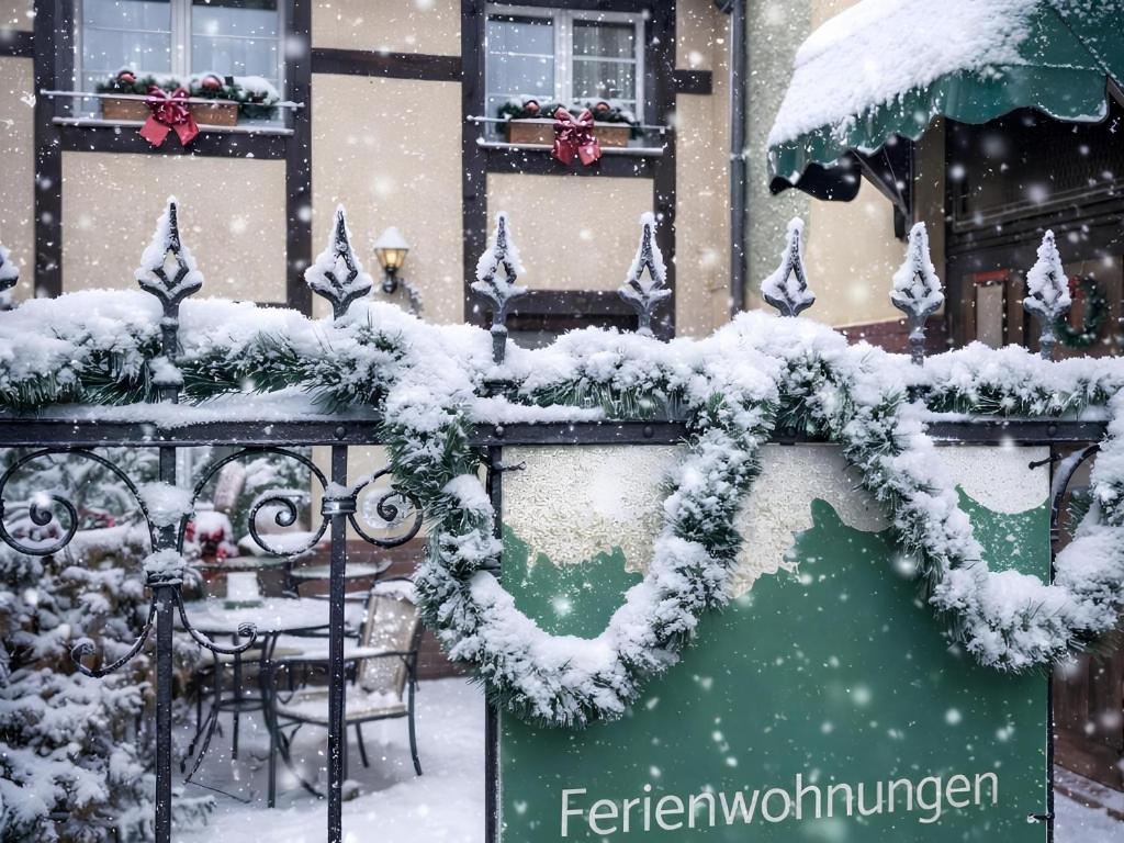 a restaurant covered in snow in front of a building at Ruhige Unterkunft im Erdgeschoss ,Nähe Schloss & UNESCO-Geopark, Waldeisenbahn, Natur und Kultur direkt vor der Tür in Bad Muskau