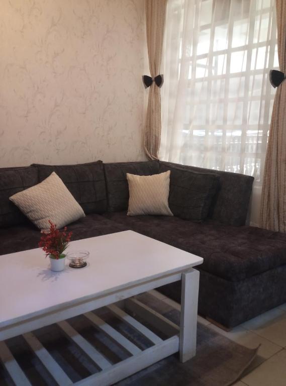 a living room with a couch and a coffee table at Victorian Haven in Eldoret