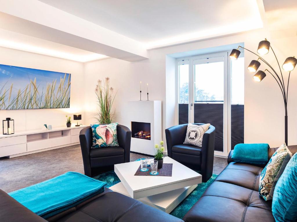 a living room with a couch and a table at Prora - Ferienwohnung mit Sauna - Meer geht immer in Binz
