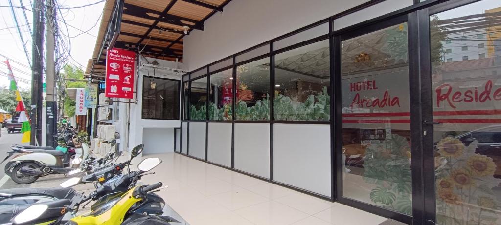 a store front with motorcycles parked outside of it at New Arcadia Residence in Jakarta