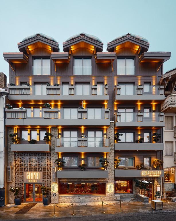 a tall building with lights on it at Maya Hôtel Courchevel 1850 in Courchevel