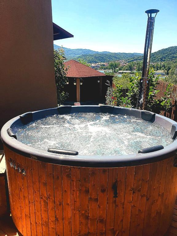 a hot tub with water in it on a patio at Casa Ostrov in Călimăneşti